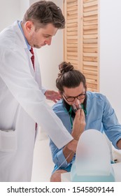 Patient Hipster Having An Asthma Attack At The Pulmonology Clinic With The Nurse Helping The Diagnosis, Doctor And Nurse Checking Patients Health