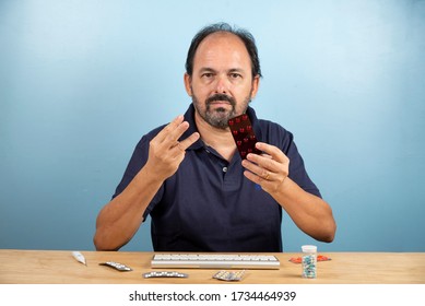 Patient Holds The Blister Card Of The Medication He Should Take.