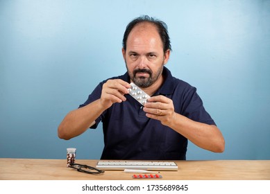 Patient Holds The Blister Card Of The Medication He Should Take.