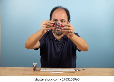 Patient Holds The Blister Card Of The Medication He Should Take.