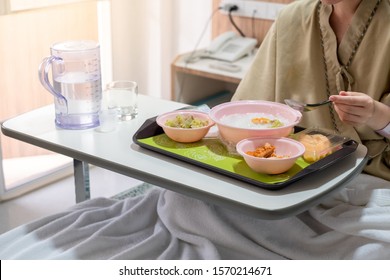 Patient and hospital concept - Asia woman patient with iv solution eating food for patient on bed in hospital and copyspace - Shutterstock ID 1570214671