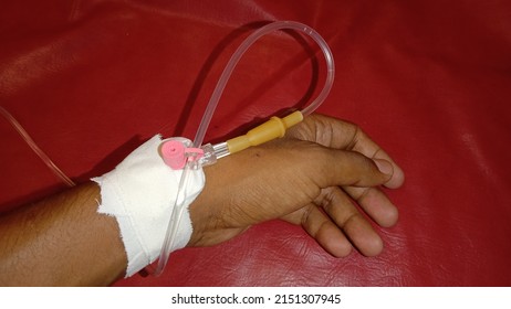 Patient In Hospital With Medical Transfusion Liquid Or Infuse On Hand With White Plaster And Cannula.