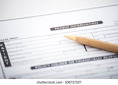 Patient Information Form And Pen On Desk,Medical Questionnaire