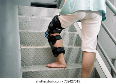 Patient With Knee Brace In Moving Upstairs 