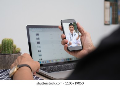 Patient Listening To Friendly Doctor Via Mobile Smartphone At Home Or Office, Telemedicine, E Health. People Watching Friendly Doctor On Health Channel Internet Live Broadcast, Medical Online Concept