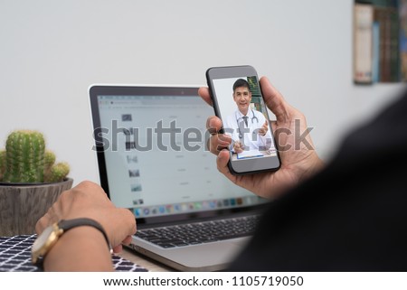 Patient listening to friendly doctor via mobile smartphone at home or office, telemedicine, e health. People watching friendly doctor on health channel internet live broadcast, medical online concept