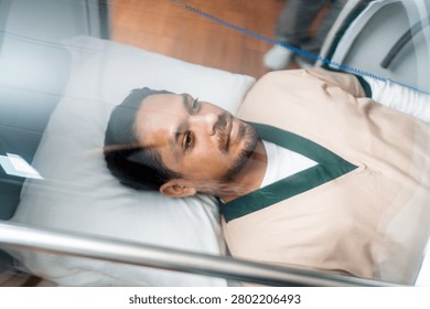 Patient lying inside a hyperbaric chamber, focusing on health, wellness, and recovery through advanced medical therapy