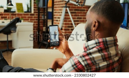 Patient lying on couch remotely discussing treatment plan with doctor during online video call meeting after medical checkup. Man receiving prescription from general practitioner in telemedicine call