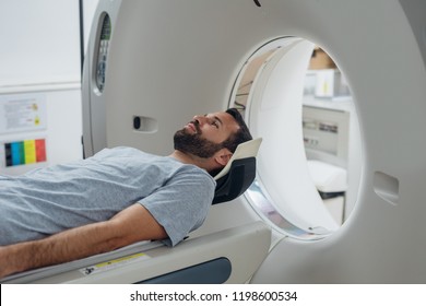 Patient lying on the TC scanner bed waiting to be scanned. - Shutterstock ID 1198600534
