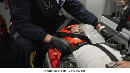 Patient, medic and man with oxygen mask in ambulance for emergency, injury or healthcare with neck brace. First responder, 911 and person with anesthesia for medical health, support or victim check - Powered by Shutterstock