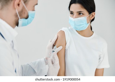 patient in medical mask in hospital and doctor vaccination injection - Shutterstock ID 1919000054