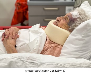 patient, old woman in emergency service of hospital because of accident. old senior woman patient has head trauma, with a swollen and bruised face from an accident, wearing a neck brace in bed - Powered by Shutterstock