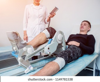 Patient On CPM (continuous Passive Range Of Motion) Machines. Leg's Rehabilitation After Injured