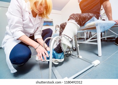 Patient On CPM (continuous Passive Range Of Motion) Machines. Device To Provide Anatomically Correct Motion To Both The Ankle And Subtalar Joints. Foot's Rehabilitation After Injured