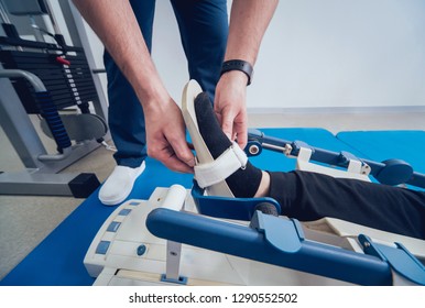 Patient On CPM (continuous Passive Range Of Motion) Machines. Device To Provide Anatomically Correct Motion To Both The Ankle And Subtalar Joints. Foot's Rehabilitation After Injured