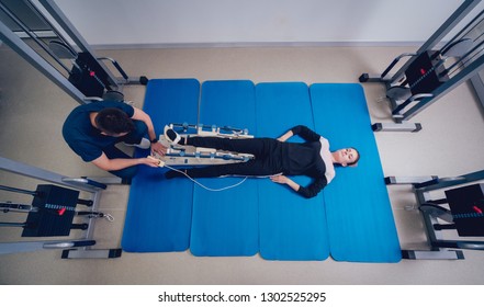 Patient On CPM (continuous Passive Range Of Motion) Machines. Device To Provide Anatomically Correct Motion To Both The Ankle And Subtalar Joints. Foot's Rehabilitation After Injured