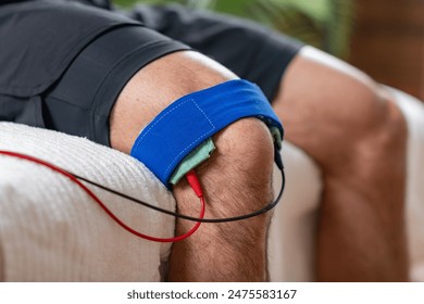 A patient on knee therapy with electrotherapy treatment for pain relief and rehabilitation. - Powered by Shutterstock