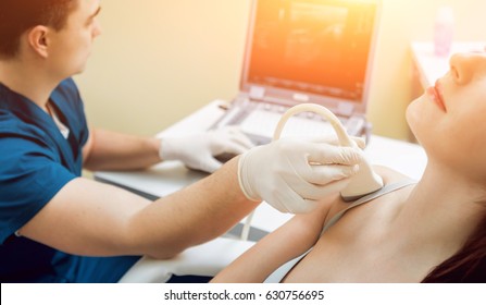 Patient with orthopedist doctor in his office. Knee sonography. - Powered by Shutterstock