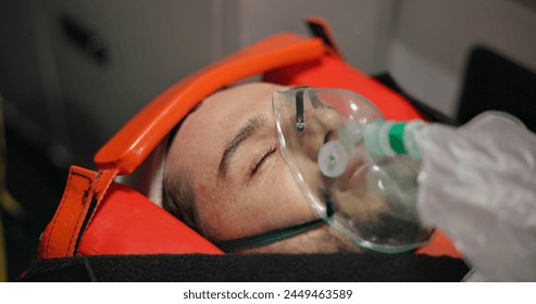 Patient, paramedic and check pupil response in emergency medical service, accident and oxygen mask. Victim, injury and test in disaster, trust and support in closeup of face, healthcare or rescue - Powered by Shutterstock