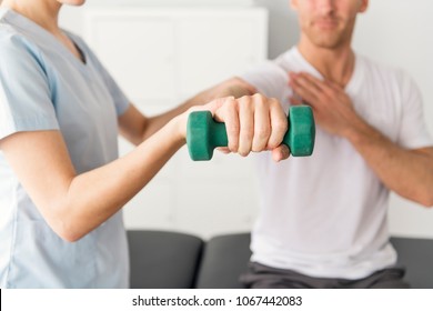 Patient at the physiotherapy doing physical exercises with his therapist - Powered by Shutterstock