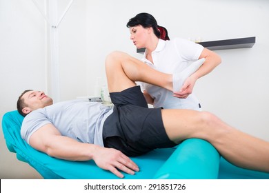 Patient At The Physiotherapy Doing Physical Exercises With His Therapist