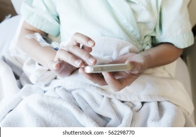 Patient  play smartphone on bed. - Powered by Shutterstock