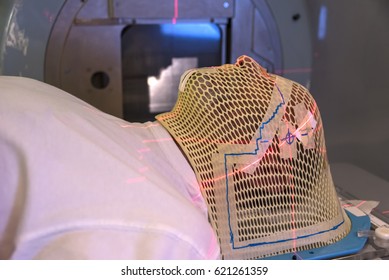 Patient Radiation therapy mask showing laser lines for targeting cancer cells in the brain