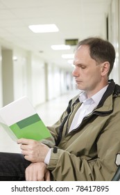 Patient Reading The Brochure In The Clinic