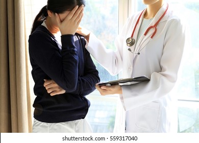 Patient receiving bad news, She is desperate and crying, Doctor support and comforting her patient with sympathy.