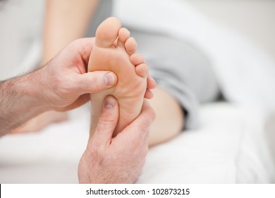 Patient receiving a foot massage in a room - Powered by Shutterstock