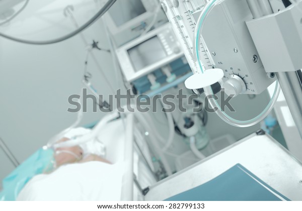 Patient receiving mechanical ventilation in a\
hospital ward