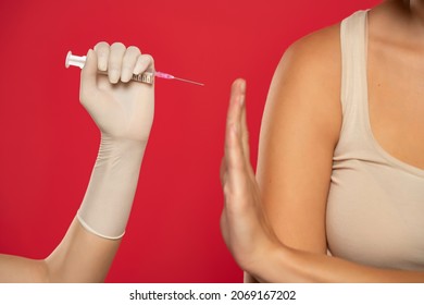 Patient Refuses To Be Vaccinated On A Red Background