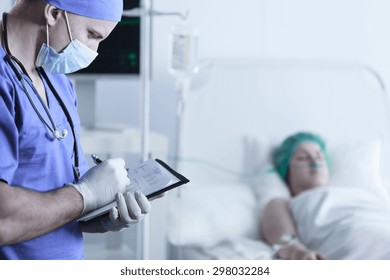 Patient Resting After Surgery And Caring Doctor