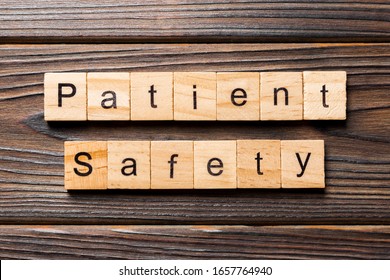 Patient Safety word written on wood block. Patient Safety text on wooden table for your desing, concept.