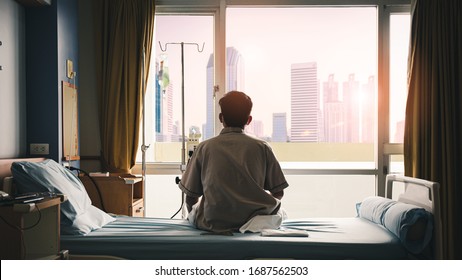 patient sat on the bed and looked out the window in the hospital alone and had stress, boredom, loneliness, anxiety. / Health care and medical - Powered by Shutterstock