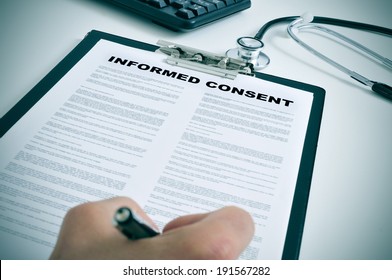 patient signing an informed consent in a doctors office - Shutterstock ID 191567282