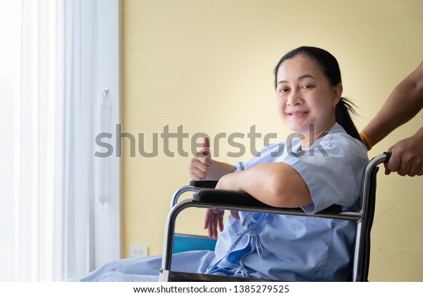 Patient sitting in a wheelchair with\
good encouragement, She lifted her finger and\
smiled.