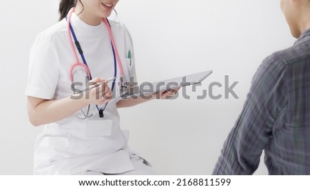 Similar – Doctor giving a prescription to senior patient