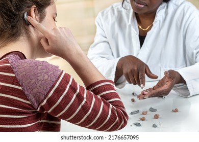 Patient Trying Different Types Of Hearing Aids. Dialoguing With His Hearing Aid Worker