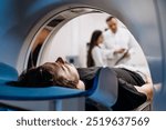 A patient undergoes an MRI or CT scan as doctors review images in a modern diagnostic center. This scene highlights the synergy between advanced technology and healthcare for accurate diagnoses.