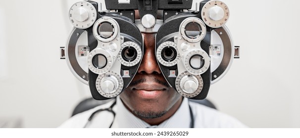 Patient undergoing an eye exam with a phoropter - Powered by Shutterstock