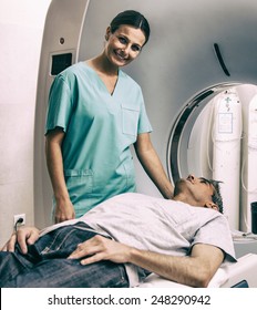 Patient Undergoing MRI At Open Scanner Machine.