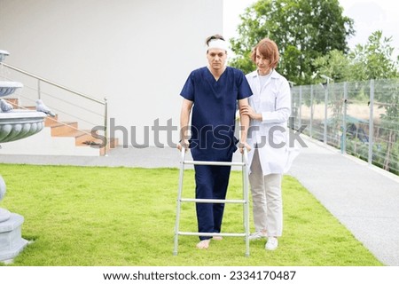 Patient using mobility walker in garden at sanatorium