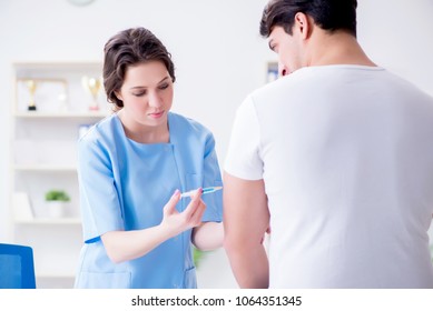 Patient Visitng Doctor For Annual Flu Shot Inoculation For Preve