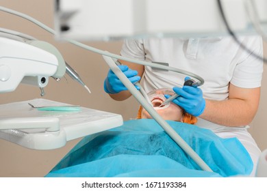 The patient visits the dentist regarding the procedure of ultrasonic cleaning of teeth in dentistry. - Shutterstock ID 1671193384