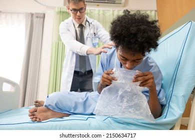 Patient Vomiting Into Plastic Bag And Doctor Helping Him In Hospital