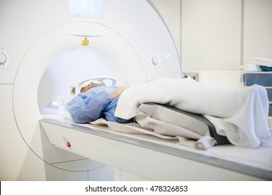 Patient Wearing Head Coil During MRI Scan In Hospital