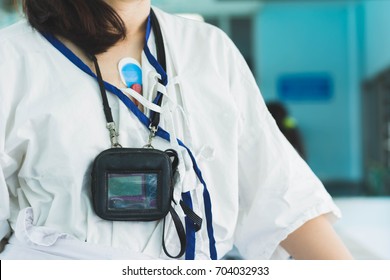 Patient Wearing Holter Monitor Device For Monitoring Of An Electrocardiogram 24 Hour Heart Investigation Activity. Woman In The Hospital. Health Care Concept