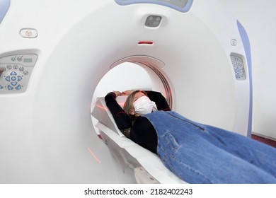 Patient Wearing Mask Into A Ct Scan Machine In An Hospital