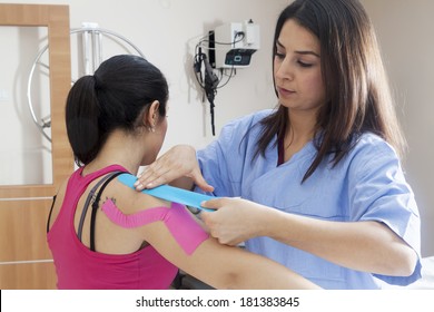 Patient wearing tapes under supervision of physical therapist